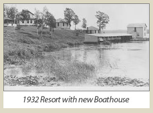 Historic photograph of the covered boathouse along the shoreline